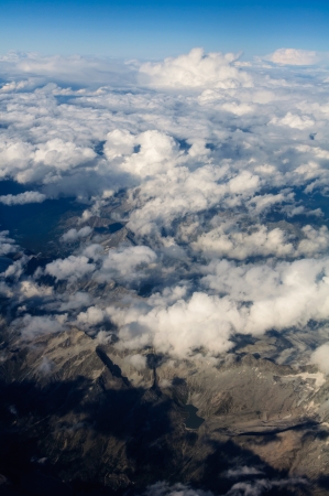 Aerial View of a Cloudscape and barren mountains below の写真素材
