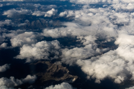 Aerial View of a Cloudscape and barren mountains below の写真素材
