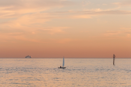 Sailboats and a cruise ship at distanceの写真素材