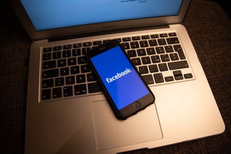New York, United States, 6th January 2021: Smartphone with Facebook logo resting on a laptop's keyboard. The biggest social network in the worldのeditorial素材
