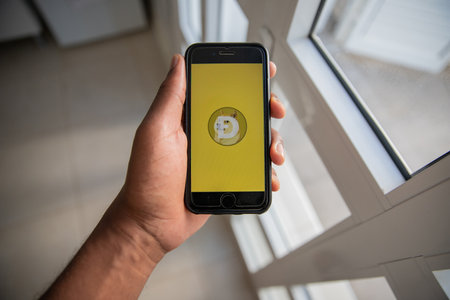 Smartphone with the Dogecoin , it is a very popular cryptocurrency created to have a payment system that is free from traditional banking feesのeditorial素材