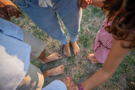A family holding hands, close-up on bare feet, concept of love and togetherness, photo with copy...