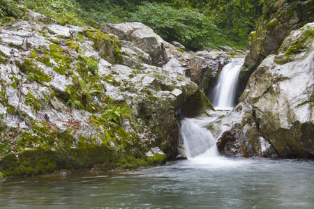 Beautiful small waterfall in the middle of a forest. italyの写真素材