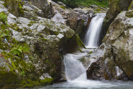 Beautiful small waterfall in the middle of a forest. italyの写真素材