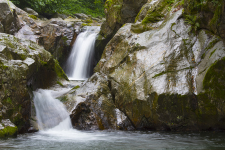 Beautiful small waterfall in the middle of a forest. italyの写真素材