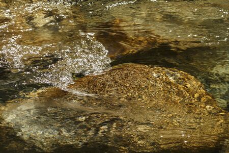 Water flowing between the rocksの写真素材