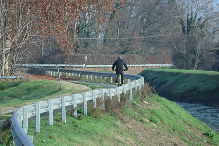 Cyclist in sports gear along the river embankmentの写真素材