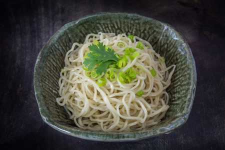 egg noodle in a bowl on dark tone backgroundの写真素材