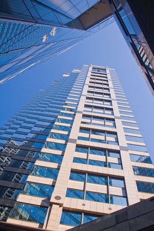Looking up to the sky surrounded by skyscrapers and office buildings