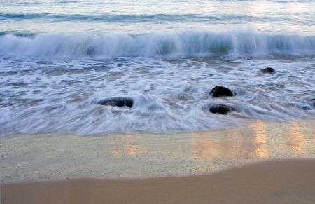 Wave breaking on Noosa Beach at sunriseの写真素材