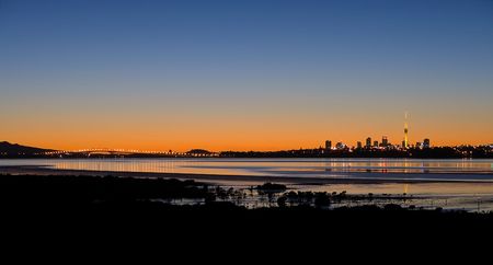 A Panorama of Auckland City, Harbour Bridge and Rangitoto Island at Sunriseの写真素材