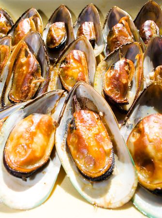 A platter of smoked New Zealand Green Lipped Mussels (Perna Canaliculus) in their shellsの写真素材
