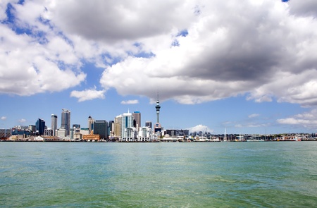 Auckland City and Sky Tower, New Zealand with cloudy skies viewed from across the harbourの写真素材