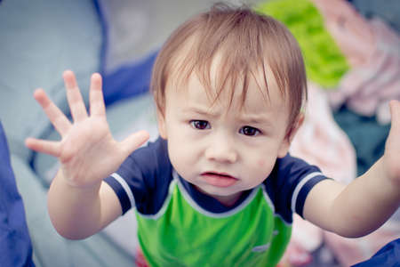 A Baby Boy Motioning That He Wants To Be Held.の写真素材