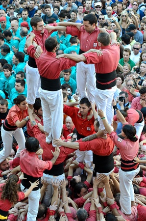 Members of "Castellers de Barcelona" build the traditional human tower at the Placa de Sant Jaume during the MercÃ© 2011 on September 25, 2011 in Barcelona, Spain.のeditorial素材