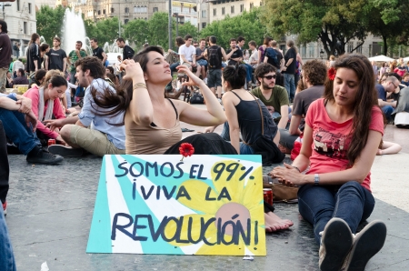 After a peaceful manifestation of several thousand 'Indignados' filled the Plaza Catalunya, the epicenter of the 15M movement, activists hold an assembly and prepare to hold the space until the 15th of May, in Barcelona, Spain on May 12th, 2012のeditorial素材