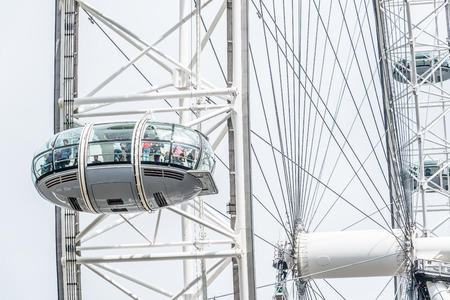 LONDON - AUGUST 27, 2014: Tourists enjoy the view over the city in the capsules of the London Eye, Europeのeditorial素材