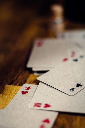 Playing cards lying wildly scattered on the floor.の写真素材