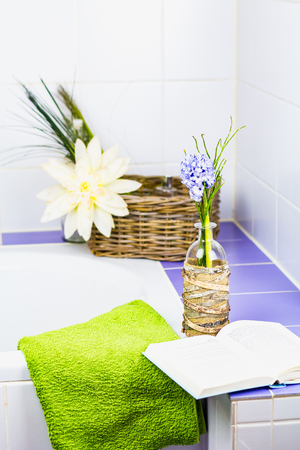 Purple hyacinth and a book at a bathtub.の写真素材