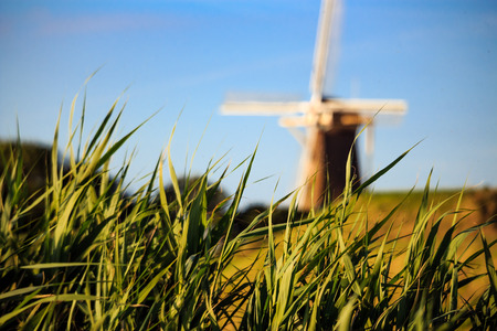 Typical windmill in holland in front of blue sky.の写真素材