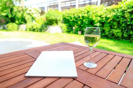 Mockup of a magazine cover on a wooden table in the garden in summer.の写真素材