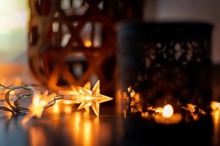 Light chain and candles create a cosy atmosphere. Romantic. Christmasの写真素材