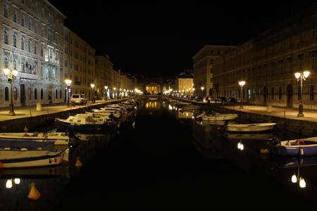 Grand Canal by night with boats moored, Trieste Italyの写真素材