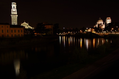 Night view of Cathedral of Verona and San Giorgio Church with reflection on the Adige river, Verona Italyの写真素材