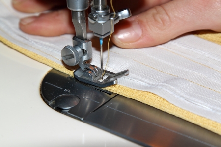 Tailor working with a sewing machineの写真素材