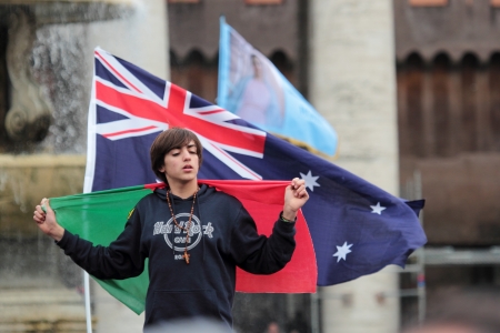ROME, ITALY - March 17: A young faithful with a flag of Portugal and of Australia in St. Peter Square before the first Angelus prayer of Pope Francis I on March 17, 2013 in Vatican City, Rome, Italyのeditorial素材