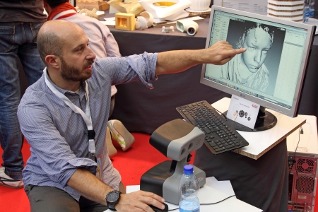ROME - OCTOBER 06: Maker explaining a rendering image at the first European Maker Faire Festival on October 06, 2013 in Rome, Italyのeditorial素材