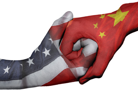 Diplomatic handshake between countries: flags of United States and China overprinted the two handsの写真素材