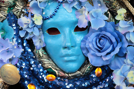 A blue mask with floral decorations exhibited during the traditional Carnival of Venice, Italy  2014 edition の写真素材