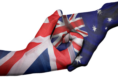 Diplomatic handshake between countries: flags of United Kingdom and Australiaoverprinted the two handsの写真素材