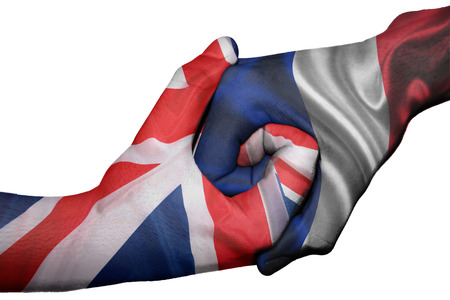 Diplomatic handshake between countries: flags of United Kingdom and France overprinted the two handsの写真素材