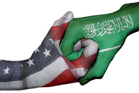 Diplomatic handshake between countries: flags of United States and Saudi Arabia overprinted the two handsの写真素材