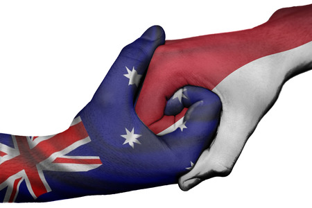 Diplomatic handshake between countries: flags of Australia and Indonesia overprinted the two handsの写真素材