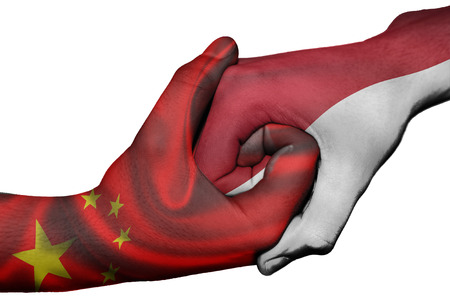 Diplomatic handshake between countries: flags of China and Indonesia overprinted the two handsの写真素材
