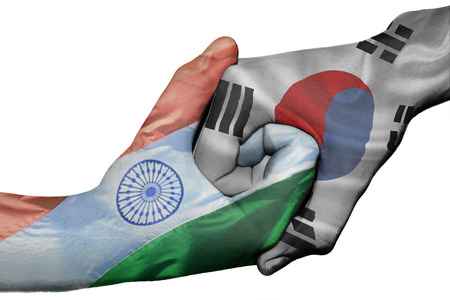 Diplomatic handshake between countries: flags of India and South Korea overprinted the two handsの写真素材