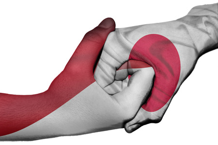 Diplomatic handshake between countries: flags of Indonesia and Japan overprinted the two handsの写真素材