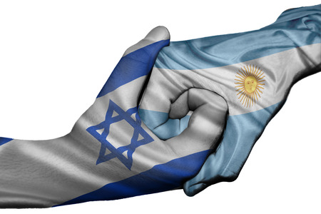 Diplomatic handshake between countries: flags of Israel and Argentina overprinted the two handsの写真素材