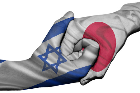 Diplomatic handshake between countries: flags of Israel and Japan overprinted the two handsの写真素材