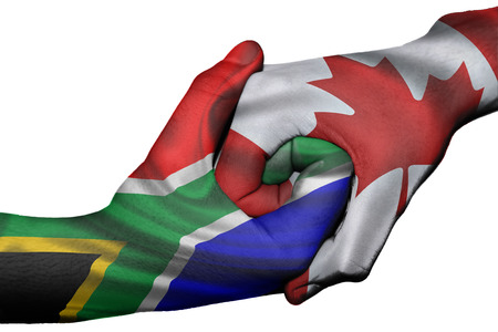 Diplomatic handshake between countries: flags of South Africa and Canada overprinted the two handsの写真素材