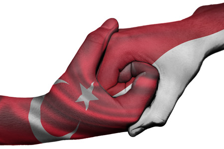 Diplomatic handshake between countries: flags of Turkey and Indonesia overprinted the two handsの写真素材