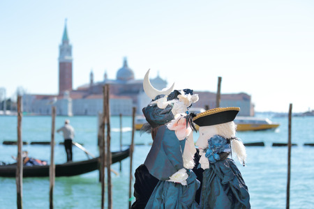 VENICE, ITALY - February 23: An unidentified woman plays her two puppets in front of the Church of San Giorgio Maggiore during the Carnival on February 23, 2014 in Venice, Italyのeditorial素材