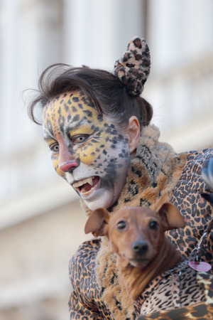 VENICE, ITALY - February 23: An unidentified woman with a dog is disguised as a leopard during the traditional festival of Carnival on February 23, 2014 in Venice, Italyのeditorial素材