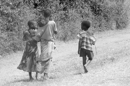 MWANZA, TANZANIA - JUNE 11: a group of children along a road on June 11, 2013 in Mwanza. In rural settings of Tanzania many children live in extreme poverty or are orphans due to HIV.のeditorial素材