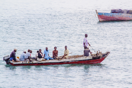 ZANZIBAR, TANZANIA - JUNE 16: people sailing on a typical water taxi on June 16, 2013 in Zanzibar. This cheap transportation is mainly used by the local populationのeditorial素材