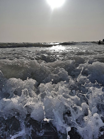 Then it breaks with reflections of the sun on the horizon.の写真素材