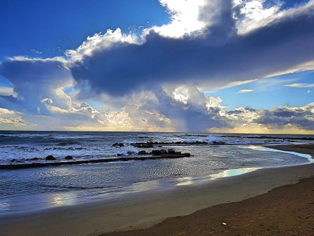 Beach and sea in winter with threatening clouds.の写真素材